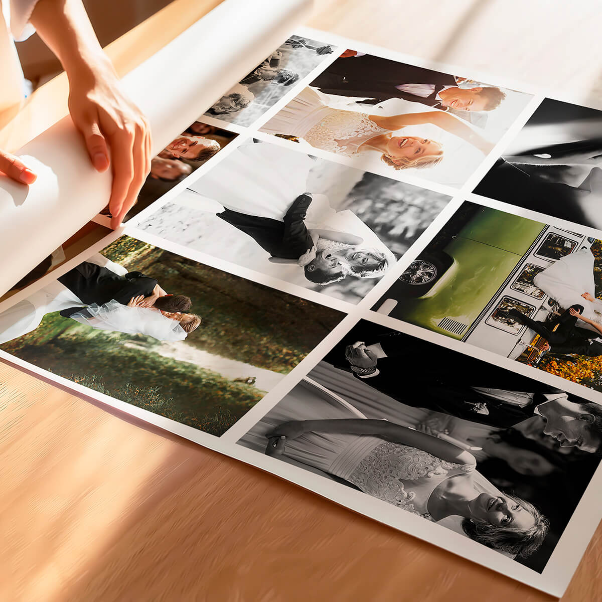 Hands carefully handling a large-format poster print roll with multiple images.