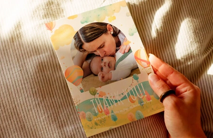 A landscape, folded baby thank you card printed with full photo